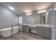 Modern bathroom with dual vanities, soaking tub, and a glass-enclosed shower with tile surround at 5641 Morning Snow Ct, Las Vegas, NV 89141