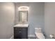 Bathroom boasts a modern vanity with silver hardware and a well-lit mirror at 5641 Morning Snow Ct, Las Vegas, NV 89141