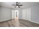 Bedroom with a ceiling fan and sliding closet doors leads to another room, showcasing the open layout at 5641 Morning Snow Ct, Las Vegas, NV 89141