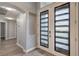 Elegant foyer featuring modern doors with decorative glass, and hardwood floors at 5641 Morning Snow Ct, Las Vegas, NV 89141