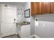 Functional laundry room featuring upper cabinets, granite countertop, and direct exterior access at 5641 Morning Snow Ct, Las Vegas, NV 89141
