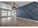 Spacious living room featuring modern wall accents, ceiling fan, and hardwood floors at 5641 Morning Snow Ct, Las Vegas, NV 89141