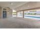 Large covered patio leading to a beautiful pool and outdoor kitchen area at 5641 Morning Snow Ct, Las Vegas, NV 89141