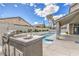 Backyard oasis with a pool, outdoor kitchen, and beautiful landscaping at 5641 Morning Snow Ct, Las Vegas, NV 89141