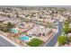 This property features a sparkling pool, lush landscaping, and is fully fenced for privacy at 5815 Pristine Falls Ave, Las Vegas, NV 89131