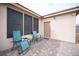 Relaxing back patio area with brick pavers and comfortable chairs overlooking the backyard at 5815 Pristine Falls Ave, Las Vegas, NV 89131