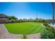 A view of the backyard showing the low maintenance lawn, gravel perimeter, and desert landscaping at 5815 Pristine Falls Ave, Las Vegas, NV 89131