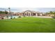 Well-maintained backyard with a large lawn, covered patio, mature landscaping and beautiful pool at 5815 Pristine Falls Ave, Las Vegas, NV 89131