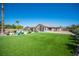 Expansive backyard with green lawn, pool, and covered patio, perfect for outdoor living and entertaining at 5815 Pristine Falls Ave, Las Vegas, NV 89131