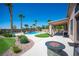 Backyard featuring inground pool and spa, fire pit, mature landscaping, and covered patio at 5815 Pristine Falls Ave, Las Vegas, NV 89131