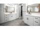Bright bathroom featuring dual vanities, quartz counters, black hardware, mirrors, and an open walk-in closet at 5815 Pristine Falls Ave, Las Vegas, NV 89131