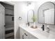 Modern bathroom featuring dual sinks, quartz counters, black hardware, mirrors, and updated fixtures at 5815 Pristine Falls Ave, Las Vegas, NV 89131