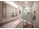 Modern bathroom featuring granite counters and a frameless glass shower at 5815 Pristine Falls Ave, Las Vegas, NV 89131