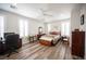Well-lit bedroom with wood floors, ceiling fan, and multiple windows at 5815 Pristine Falls Ave, Las Vegas, NV 89131