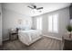 This bedroom offers plush carpet, a ceiling fan, and bright windows with plantation shutters at 5815 Pristine Falls Ave, Las Vegas, NV 89131