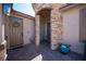 Inviting front entrance with stone accents, brick flooring, and colorful floral decorations at 5815 Pristine Falls Ave, Las Vegas, NV 89131