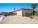 Side view of a desert home featuring stucco walls, desert landscaping, and a gated side yard at 5815 Pristine Falls Ave, Las Vegas, NV 89131