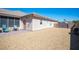 Exterior view of the home with a gravel yard and patio area, and a private entrance at 5815 Pristine Falls Ave, Las Vegas, NV 89131