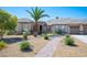 Charming single-story home with a well-manicured front yard, desert landscaping, and a brick walkway at 5815 Pristine Falls Ave, Las Vegas, NV 89131