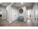 Neutral hallway features wood-look tile flooring, a closet, and an accent bench with decor at 5815 Pristine Falls Ave, Las Vegas, NV 89131