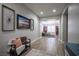 Long hallway with wood floors, neutral paint, and decorative wall art at 5815 Pristine Falls Ave, Las Vegas, NV 89131