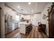 Bright kitchen with white cabinets, stainless steel appliances and large island at 5815 Pristine Falls Ave, Las Vegas, NV 89131
