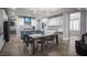 Open kitchen with dining area, white cabinets, granite countertops, and stainless steel appliances at 5815 Pristine Falls Ave, Las Vegas, NV 89131