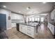 Open kitchen with white cabinets, granite counters, stainless appliances, and open to the living area at 5815 Pristine Falls Ave, Las Vegas, NV 89131