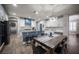 Eat-in kitchen with modern island and countertop seating, and a rustic wood-look tile floor at 5815 Pristine Falls Ave, Las Vegas, NV 89131