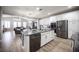 Open kitchen with stainless appliances, granite countertops, and an island overlooking the living room at 5815 Pristine Falls Ave, Las Vegas, NV 89131
