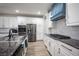Bright kitchen featuring stainless appliances, granite countertops, and white cabinetry at 5815 Pristine Falls Ave, Las Vegas, NV 89131