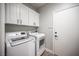 This laundry room has ample storage and modern appliances at 5815 Pristine Falls Ave, Las Vegas, NV 89131
