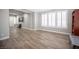 Open-concept living area with a large window offers plenty of natural light and wood-look tile floors at 5815 Pristine Falls Ave, Las Vegas, NV 89131