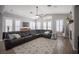 Spacious living room with vaulted ceilings, fireplace, tile floors, large sectional and plantation shutters at 5815 Pristine Falls Ave, Las Vegas, NV 89131