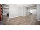 Spacious living room with wood-look tile flooring flowing into the open kitchen and entry at 5815 Pristine Falls Ave, Las Vegas, NV 89131