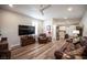 This living room has wood floors, a ceiling fan, and lots of natural light at 5815 Pristine Falls Ave, Las Vegas, NV 89131