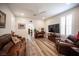 Inviting living room featuring a ceiling fan, laminate floors, and comfortable leather furniture at 5815 Pristine Falls Ave, Las Vegas, NV 89131