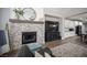 Open-concept living space features a fireplace, media center, tile flooring, and stylish furniture at 5815 Pristine Falls Ave, Las Vegas, NV 89131