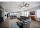Open-concept living room with vaulted ceilings, wood floors, and a view of the kitchen and dining area at 5815 Pristine Falls Ave, Las Vegas, NV 89131