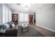 Cozy living room with wood floors, plantation shutters, comfortable seating, and bookcases at 5815 Pristine Falls Ave, Las Vegas, NV 89131