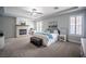 Inviting main bedroom with tray ceiling, fireplace, carpet, access to a patio and ensuite bathroom at 5815 Pristine Falls Ave, Las Vegas, NV 89131