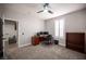Home office with gray walls, shutters, dark wood bookcase, desk, and gray carpet at 5815 Pristine Falls Ave, Las Vegas, NV 89131
