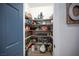 Organized walk-in pantry features wood shelves and ample storage space for food and kitchen essentials at 5815 Pristine Falls Ave, Las Vegas, NV 89131