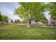Scenic view of a neighborhood park featuring mature shade trees and lush green grass, community amenity at 5815 Pristine Falls Ave, Las Vegas, NV 89131