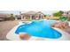 Stunning backyard with a private pool, spa, and rock waterfall feature, ideal for outdoor living at 5815 Pristine Falls Ave, Las Vegas, NV 89131