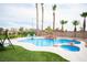 Backyard pool featuring a rock waterfall, mature palm trees, and a built-in jacuzzi at 5815 Pristine Falls Ave, Las Vegas, NV 89131