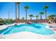 Resort-style pool and spa surrounded by lush landscaping and tall palm trees create a private oasis at 5815 Pristine Falls Ave, Las Vegas, NV 89131