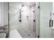 Modern shower with gray tile, black fixtures, glass doors, patterned floor tile, and a built-in niche at 5815 Pristine Falls Ave, Las Vegas, NV 89131