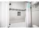 Updated bathroom featuring gray tiled shower with built in niche and a shower curtain at 5815 Pristine Falls Ave, Las Vegas, NV 89131