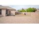 Gravel side yard with fencing and mature shade trees at 5815 Pristine Falls Ave, Las Vegas, NV 89131